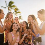 Two women applying makeup outdoors in Florida &mdash; seasonal beauty routine