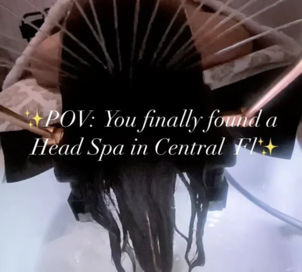 A woman relaxing in a head spa chair with her hair washed.