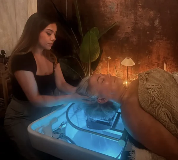 Therapist applying scalp serum during a head spa treatment