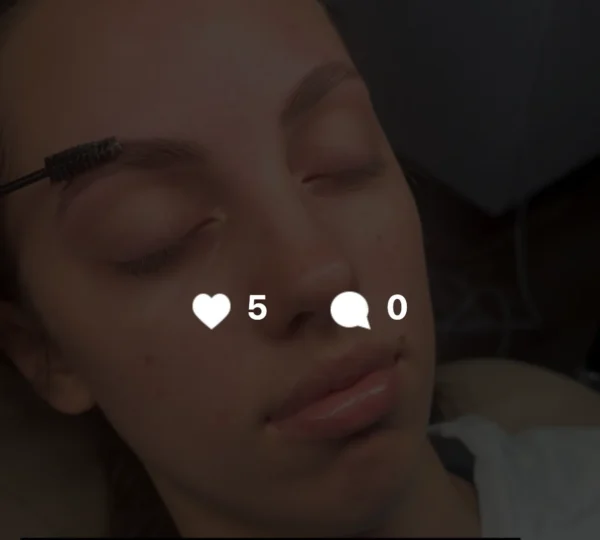 Person applying eyebrow gel in a cozy bathroom setting
