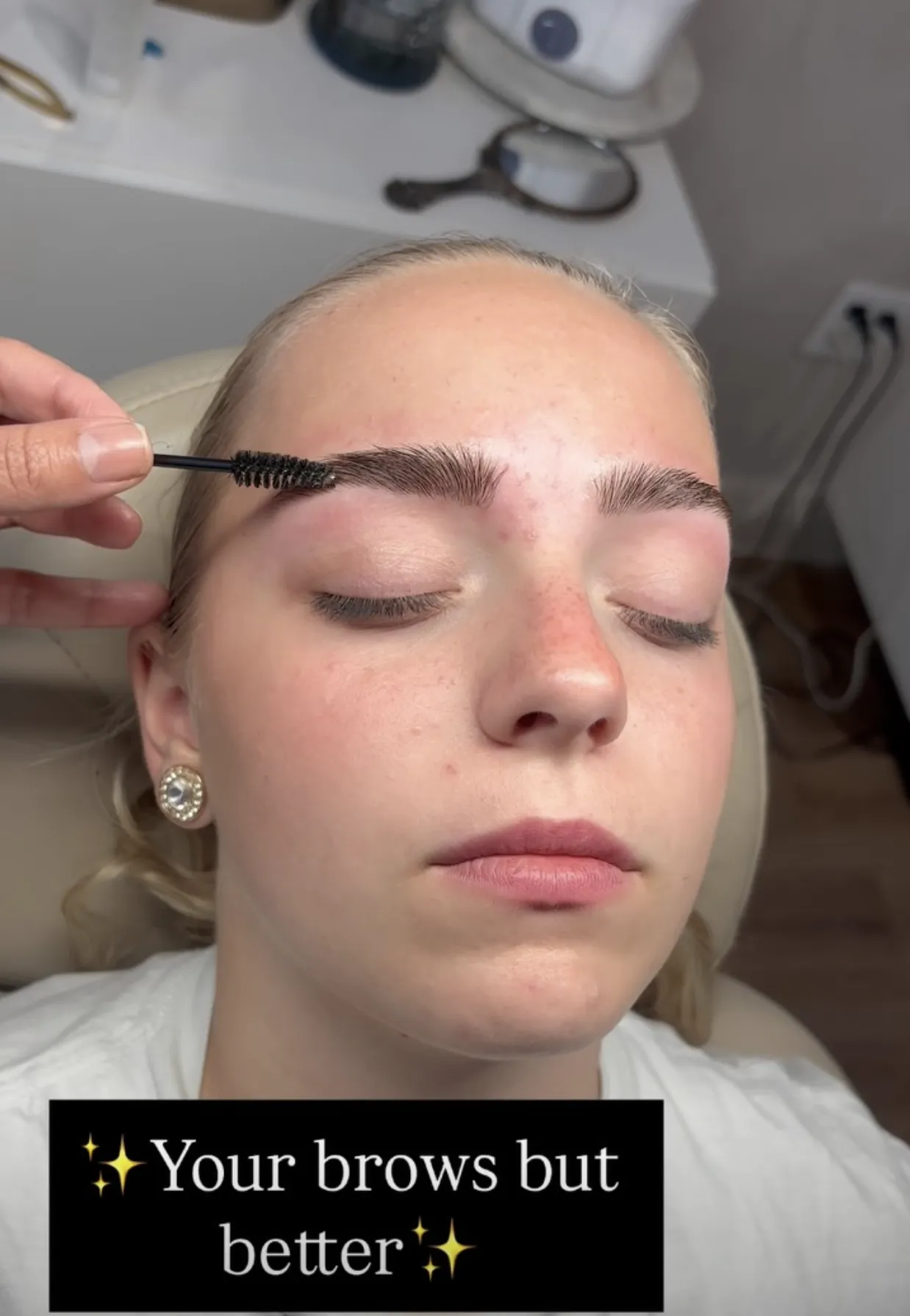 Microblading tool creating fine strokes on an eyebrow for a natural look